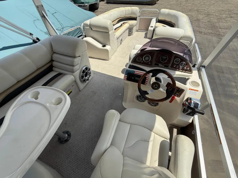 Slide: The Image of 2011 Tahoe Pontoon Double Decker interior with plush seating and modern dashboard. - 19