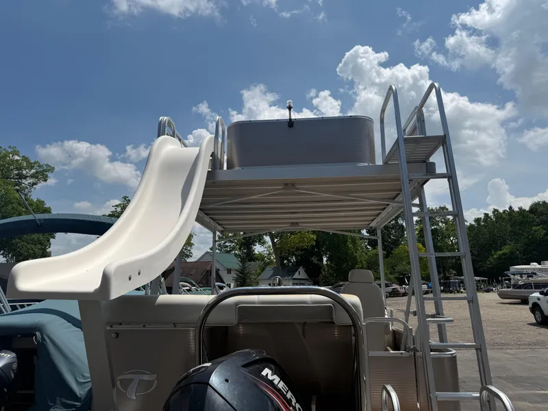 Slide: The Image of 2011 Tahoe Pontoon Double Decker with slide and ladder under a blue sky. - 3