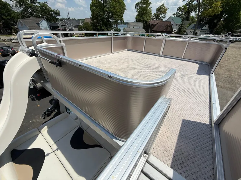 Slide: The Image of 2011 Tahoe Pontoon Double Decker with upper deck and slide, parked near residential area. - 6