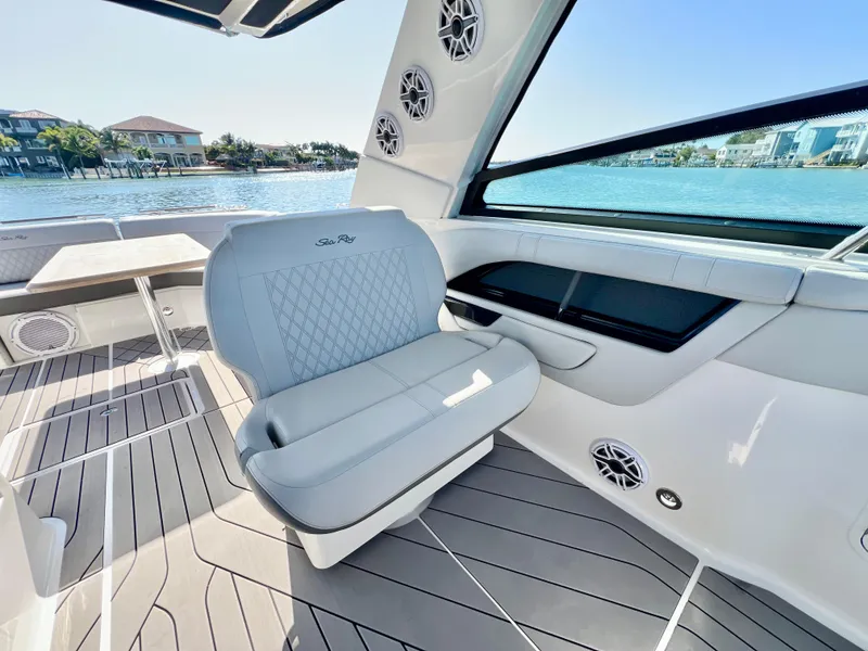 Slide: The Image of 2022 Sea Ray SLX 400 OB boat interior with luxurious seating and waterfront view. - 13