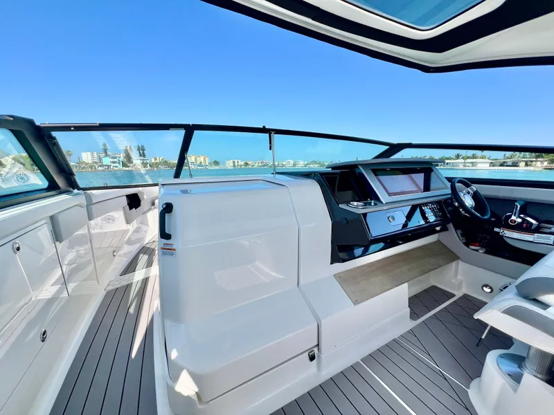 Slide: The Image of 2022 Sea Ray SLX 400 OB boat interior with modern helm and waterfront view. - 14