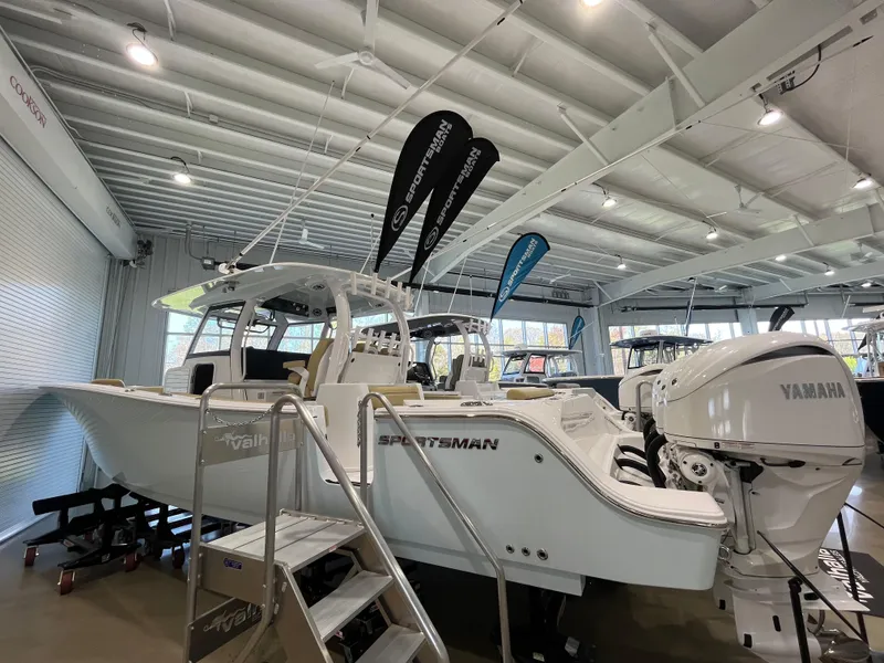 Slide: The Image of 2025 Sportsman Open 352 Center Console boat displayed indoors with Yamaha engine. - 0