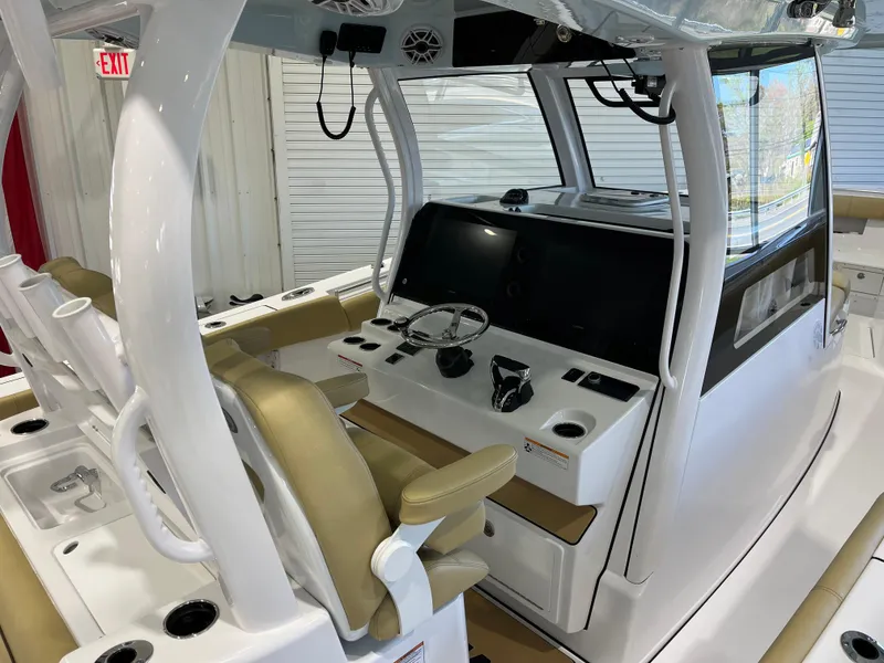Slide: The Image of 2025 Sportsman Open 352 Center Console interior with beige seating and modern controls. - 1