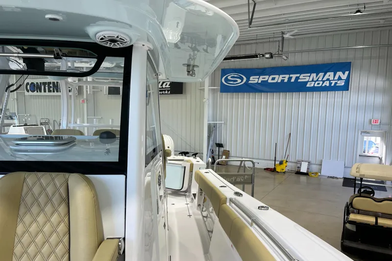 Slide: The Image of 2025 Sportsman Open 352 Center Console boat in showroom with branded banner. - 10