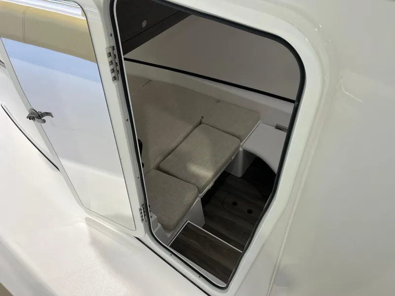 Slide: The Image of 2025 Sportsman Open 352 Center Console cabin interior with cushioned seating. - 13