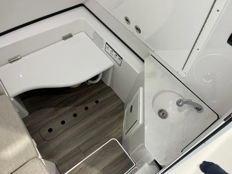 Slide: The Image of 2025 Sportsman Open 352 Center Console interior with sink and seating area. - 14