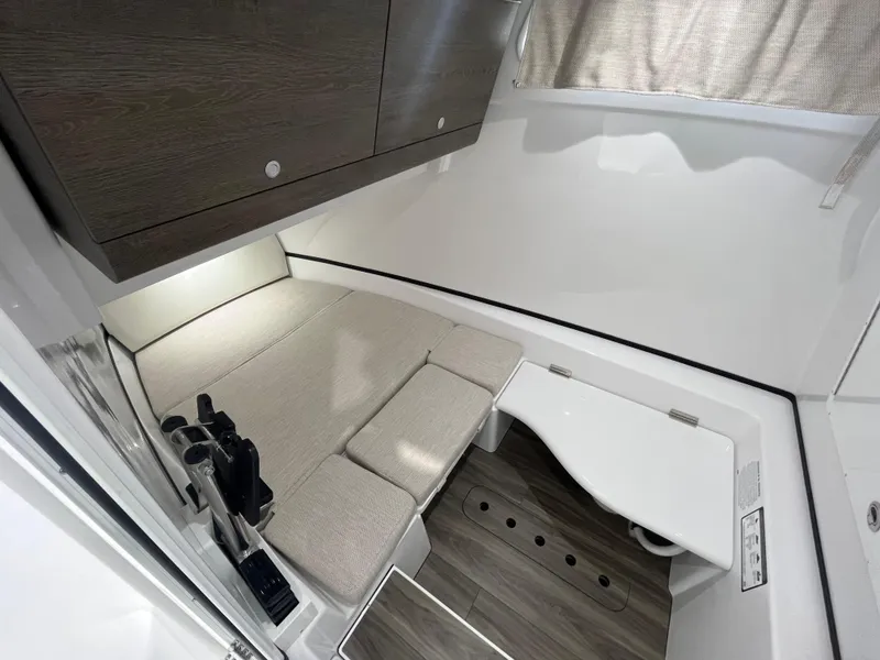 Slide: The Image of 2025 Sportsman Open 352 Center Console cabin interior with seating and storage. - 15