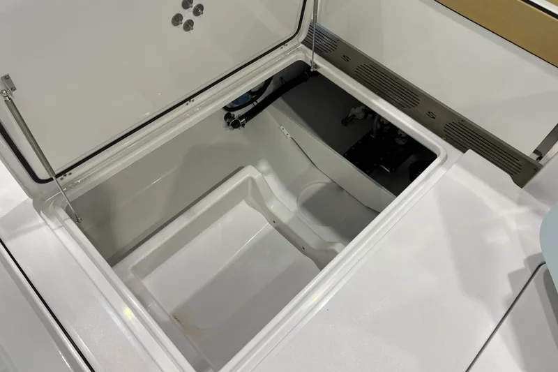 Slide: The Image of 2025 Sportsman Open 352 Center Console storage compartment, open and empty. - 18