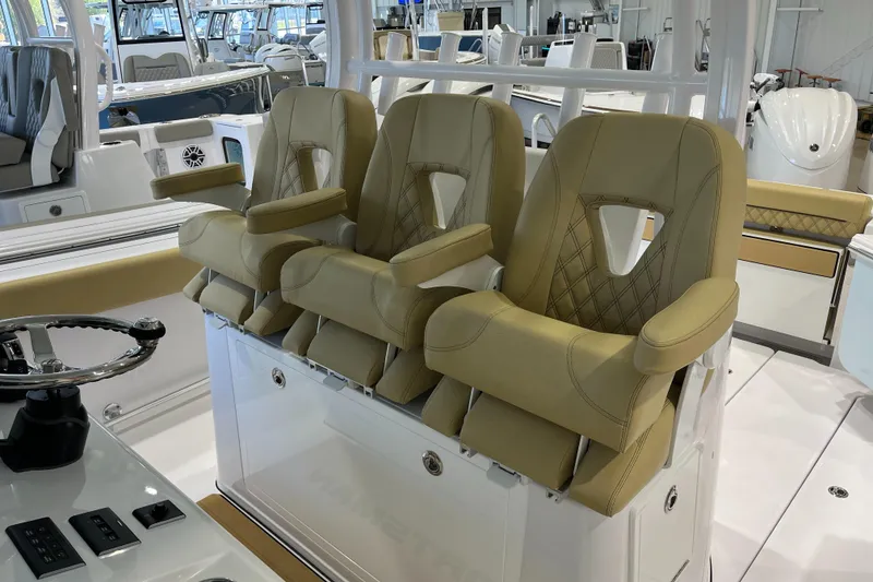 Slide: The Image of 2025 Sportsman Open 352 Center Console with luxurious beige seating and modern helm controls. - 2