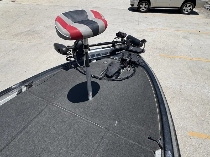 Slide: The Image of 2018 Skeeter FX 21 boat deck with seat and trolling motor in parking lot. - 5