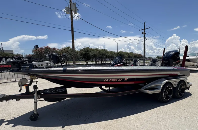 Slide: The Image of 2018 Skeeter FX 21 boat on trailer under clear blue sky. - 7