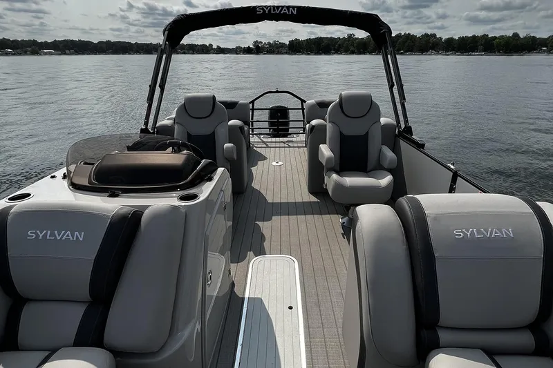 Slide: The Image of 2026 Sylvan L3 RLZ pontoon boat with sleek design and powerful outboard motor. - 7