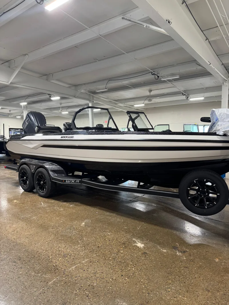 The Image of 2025 Skeeter WXR 2260 boat on trailer in indoor showroom. - 1