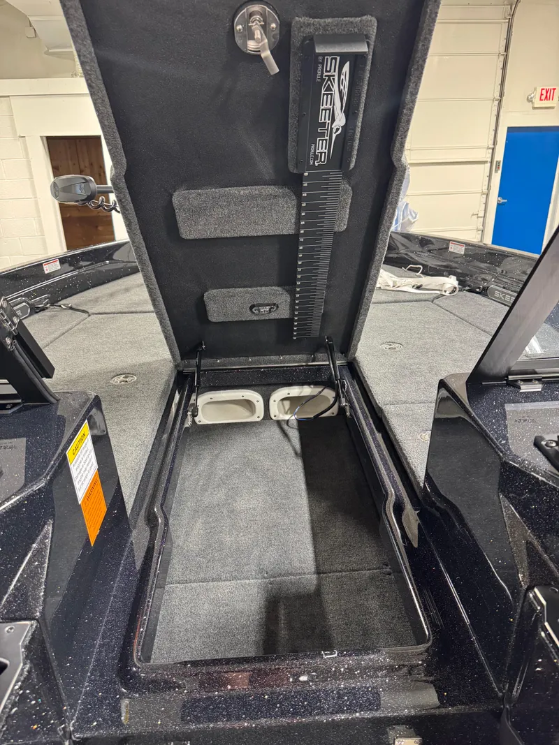 Slide: The Image of Open storage compartment in 2025 Skeeter WXR 2260 boat, showcasing interior design and features. - 12