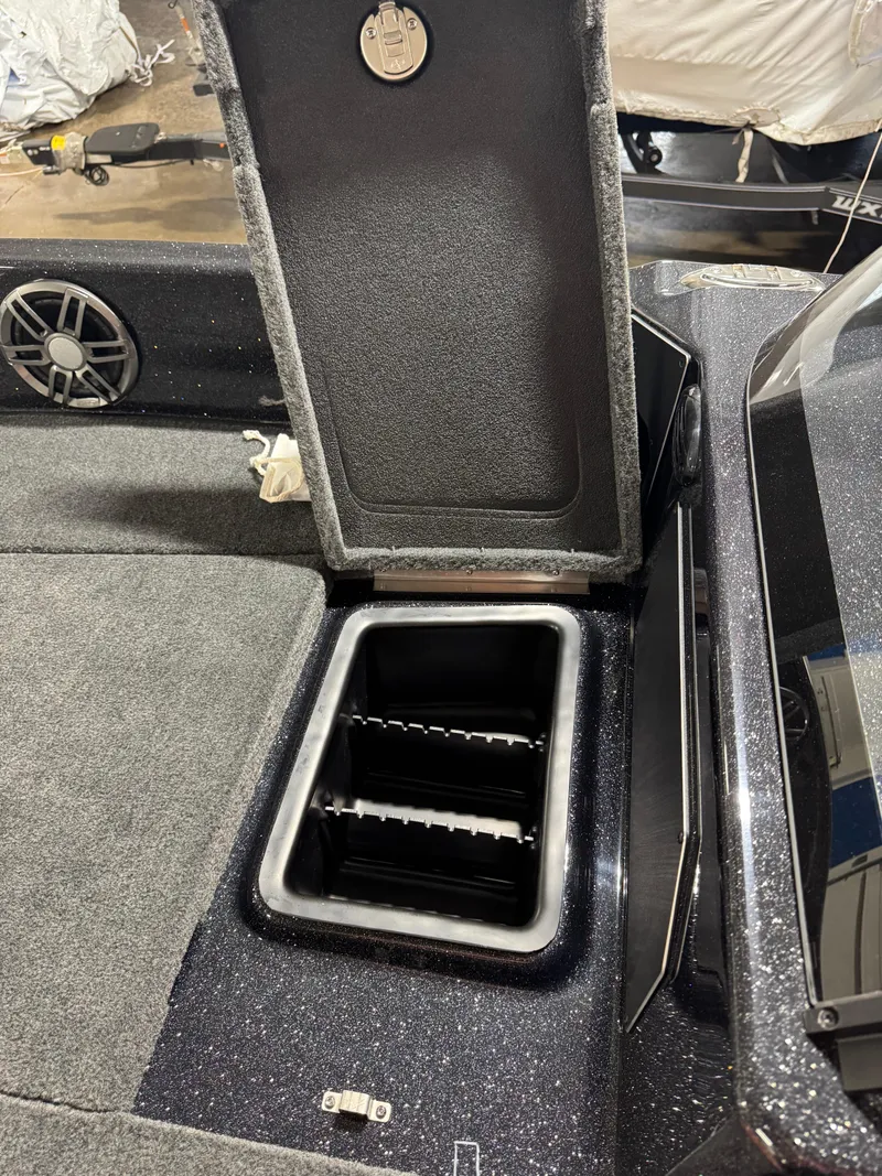 Slide: The Image of Open storage compartment in 2025 Skeeter WXR 2260 boat interior. - 14