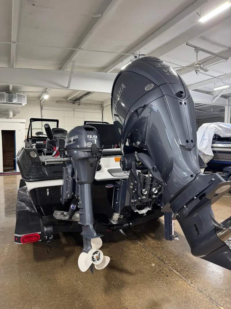 Slide: The Image of 2025 Skeeter WXR 2260 boat with dual Yamaha outboard motors in a showroom. - 3
