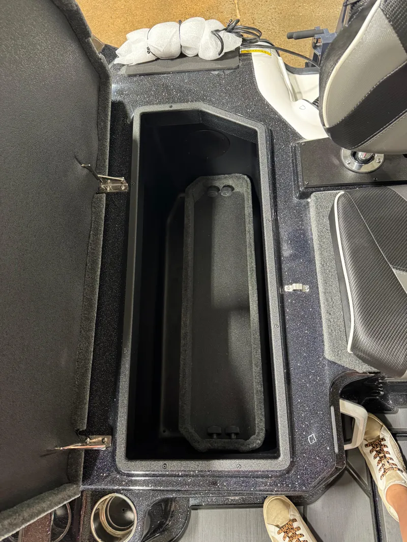 Slide: The Image of Open storage compartment in 2025 Skeeter WXR 2260 boat, featuring spacious interior and seating. - 5