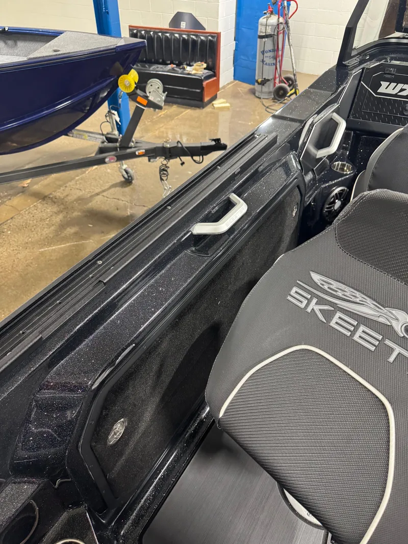 Slide: The Image of 2025 Skeeter WXR 2260 boat interior with branded seat and handle detail. - 7