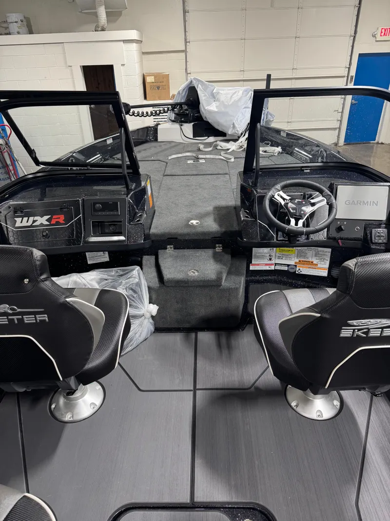 Slide: The Image of 2025 Skeeter WXR 2260 boat interior with dual seats and Garmin navigation system. - 8
