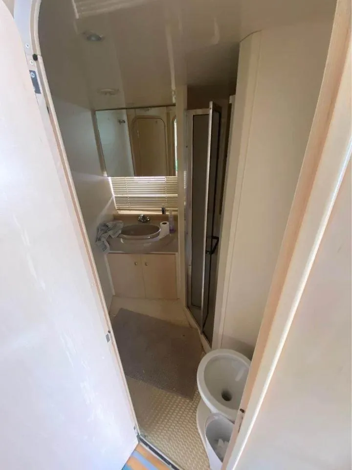 Slide: The Image of 1999 Carver 350 Mariner bathroom interior with sink, toilet, and shower. - 14
