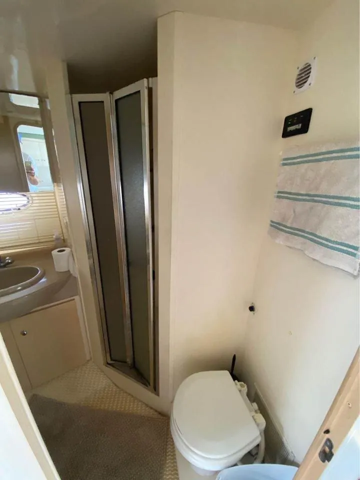 Slide: The Image of 1999 Carver 350 Mariner bathroom with shower, sink, and toilet. - 16