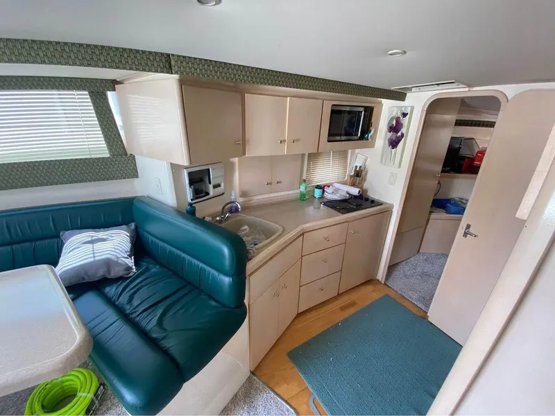Slide: The Image of Interior of 1999 Carver 350 Mariner yacht with kitchen and seating area. - 17