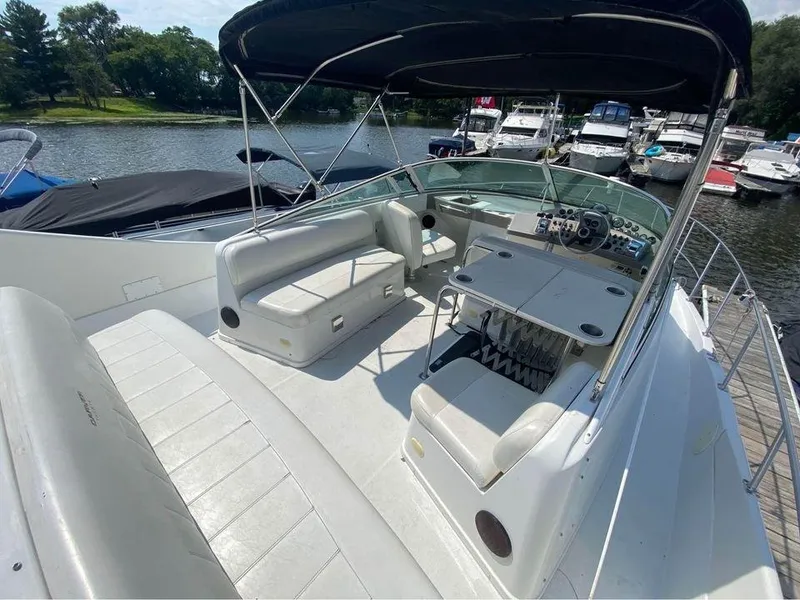 Slide: The Image of 1999 Carver 350 Mariner boat with spacious deck, seating, and helm, docked at marina. - 21