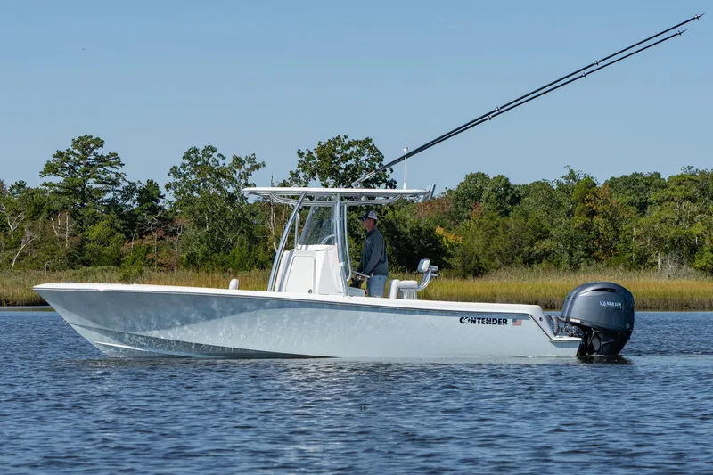 The Image of 2026 Contender 25T boat on water with Yamaha engine, surrounded by trees. - 1