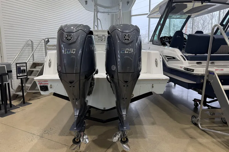 Slide: The Image of 2026 Contender 25 Tournament boat with dual Yamaha 200 outboard engines in showroom. - 12