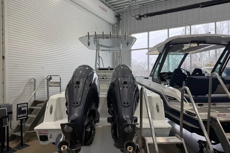 Slide: The Image of 2026 Contender 25 Tournament boat with dual engines in showroom. - 13