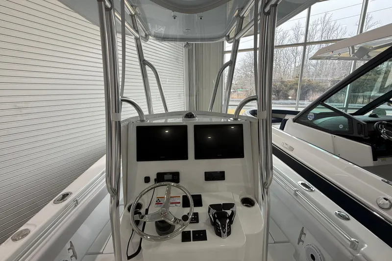 Slide: The Image of 2026 Contender 25 Tournament boat cockpit with dual screens and steering wheel. - 17