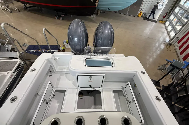 Slide: The Image of 2026 Contender 25 Tournament boat interior with dual engines in showroom. - 20