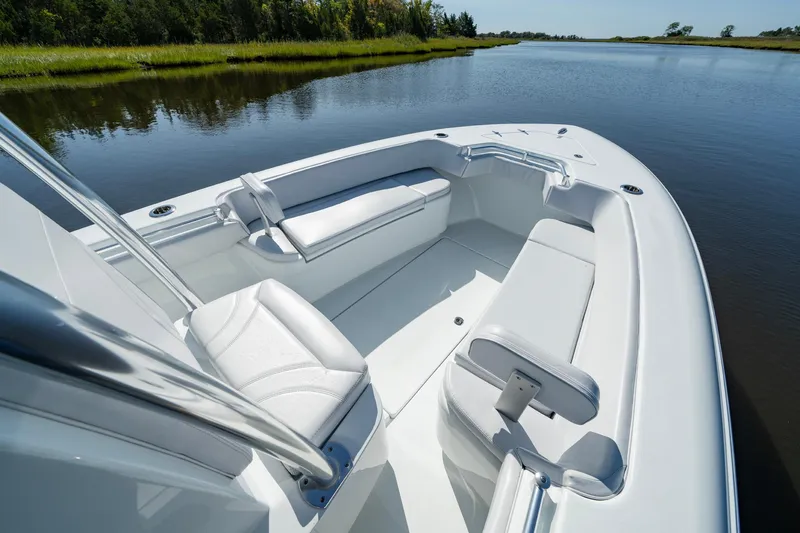 Slide: The Image of 2026 Contender 25T boat interior with white seating on a calm river. - 6