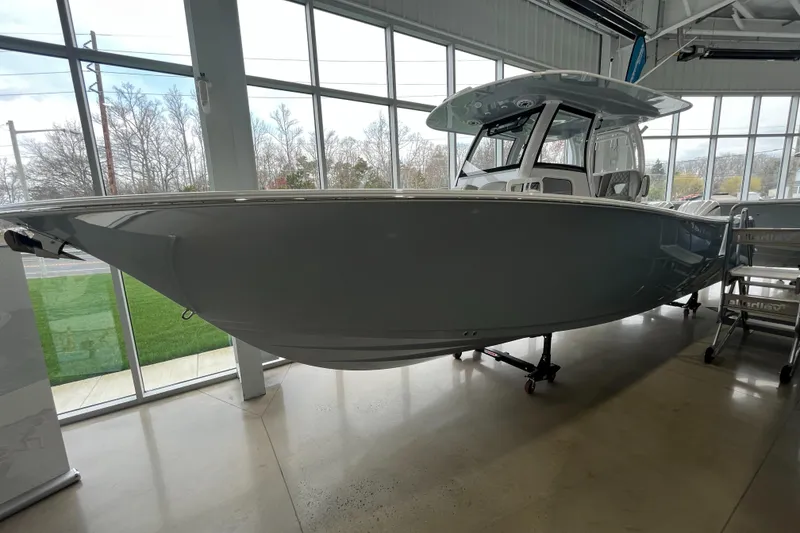 Slide: The Image of 2025 Sportsman Open 302 Center Console boat displayed indoors. - 1