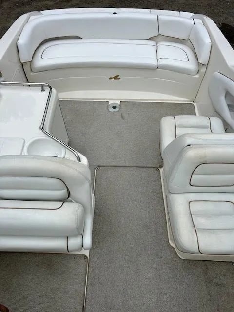 Slide: The Image of 1998 Sea Ray 28 CC boat interior with white seating and carpeted floor. - 10