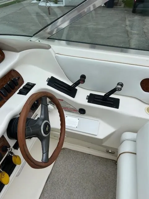 Slide: The Image of Interior of a 1998 Sea Ray 28 CC boat showing steering wheel and controls. - 11