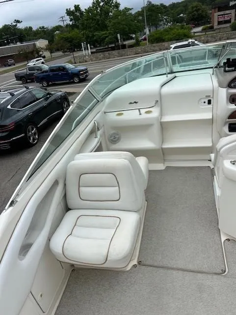 Slide: The Image of 1998 Sea Ray 28 CC boat interior with white seating and dashboard. - 14