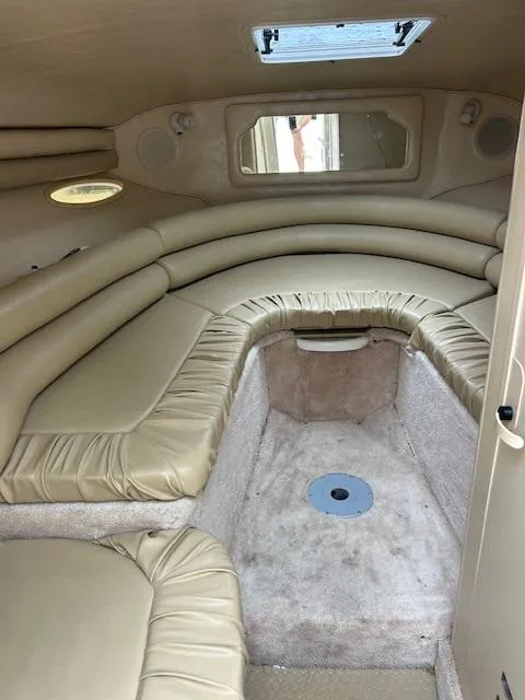 Slide: The Image of Interior cabin of a 1998 Sea Ray 28 CC boat with beige seating. - 18