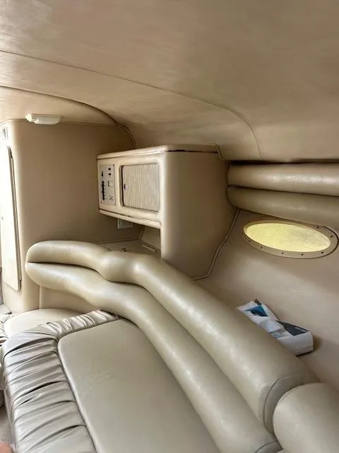 Slide: The Image of Interior of 1998 Sea Ray 28 CC boat with beige seating and storage compartments. - 20
