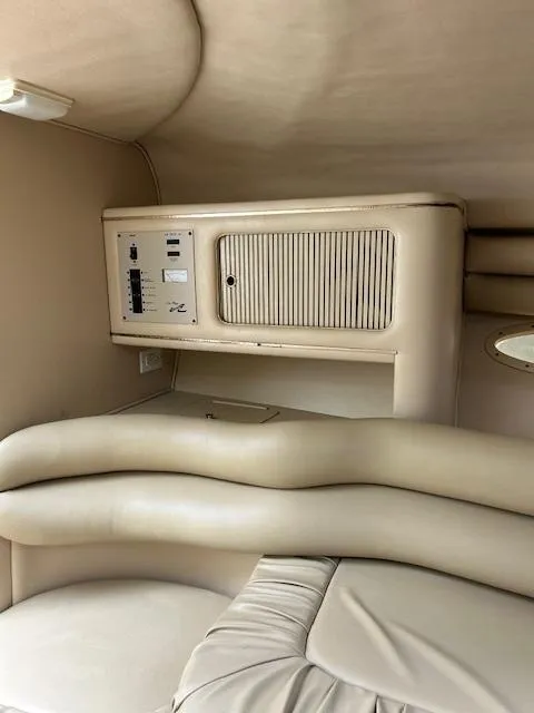Slide: The Image of Interior of 1998 Sea Ray 28 CC boat with beige seating and control panel. - 24