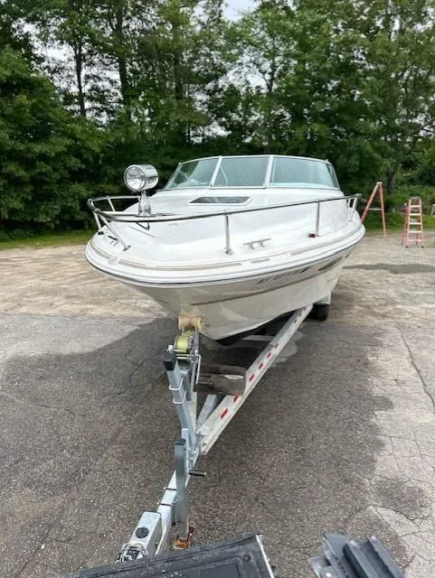 Slide: The Image of 1998 Sea Ray 28 CC boat on trailer, parked outdoors with trees in background. - 3