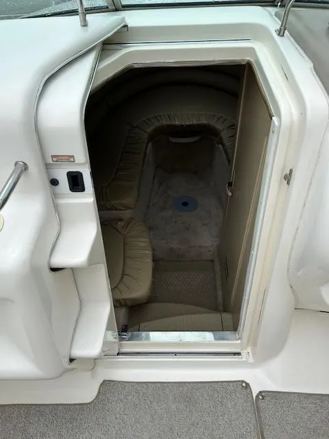 Slide: The Image of Interior cabin view of a 1998 Sea Ray 28 CC boat, showing seating and entrance. - 6