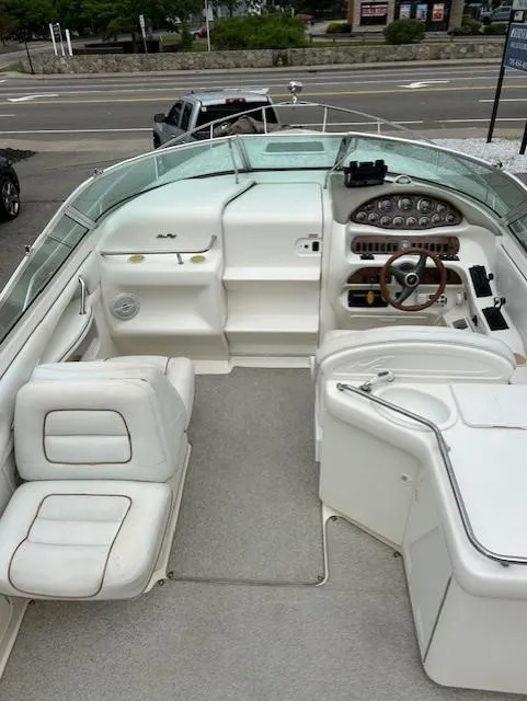 Slide: The Image of 1998 Sea Ray 28 CC boat interior with white seating and control panel. - 9