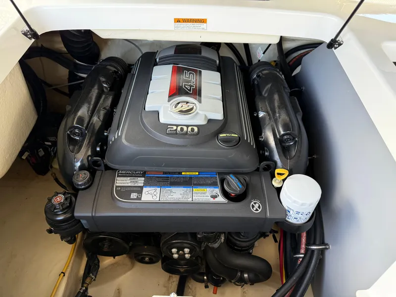 Slide: The Image of Engine compartment of a 2016 Monterey 196MS boat featuring a Mercury 4.5L 200 HP engine. - 10