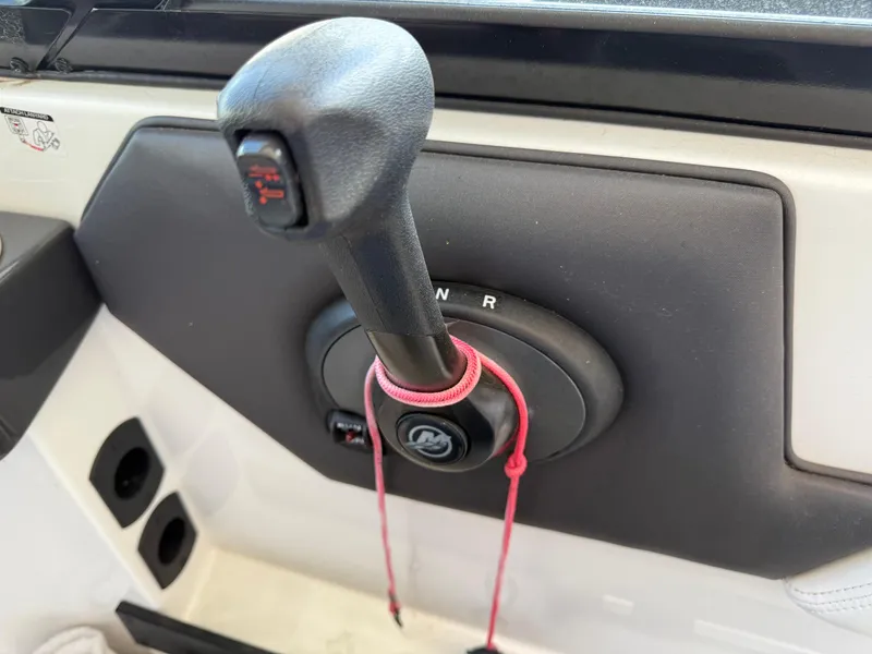 Slide: The Image of Close-up of a 2016 Monterey 196MS boat throttle control with safety lanyard. - 18