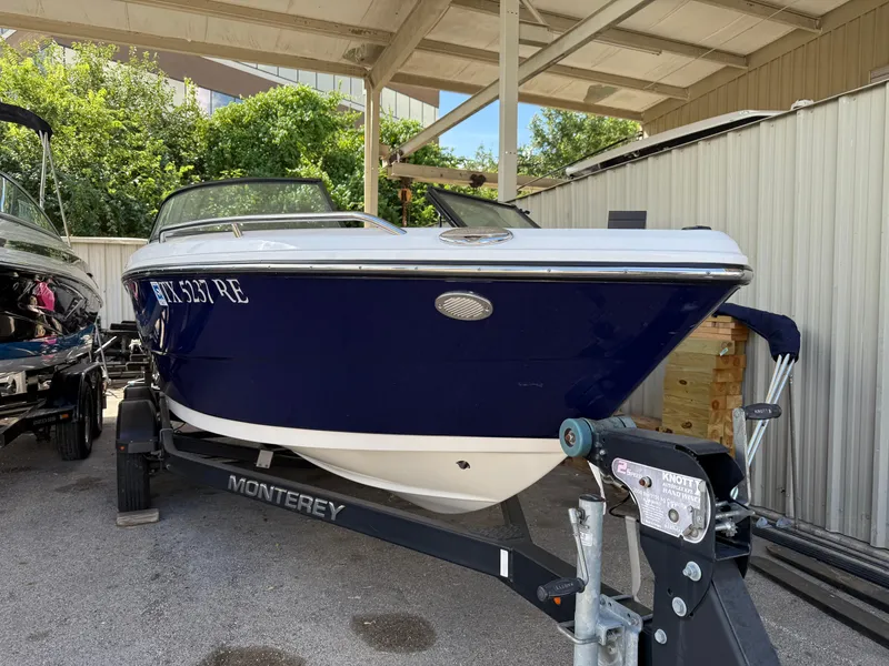 Slide: The Image of 2016 Monterey 196MS boat on trailer, parked under a shelter. - 2