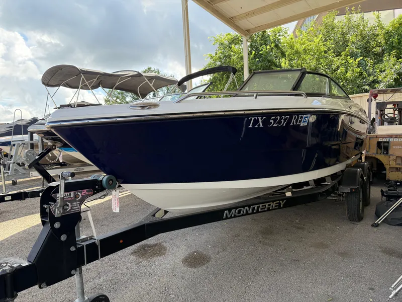 Slide: The Image of 2016 Monterey 196MS boat on trailer under canopy, parked outdoors. - 3