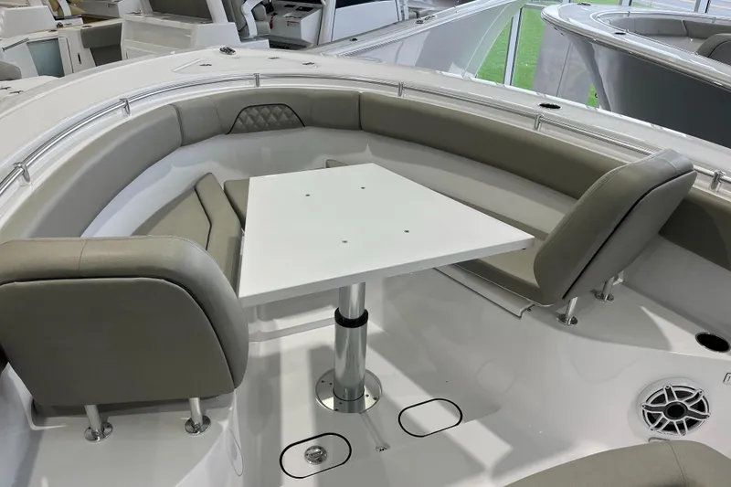 Slide: The Image of 2025 Sportsman Open 282 Center Console boat interior with seating and table. - 12