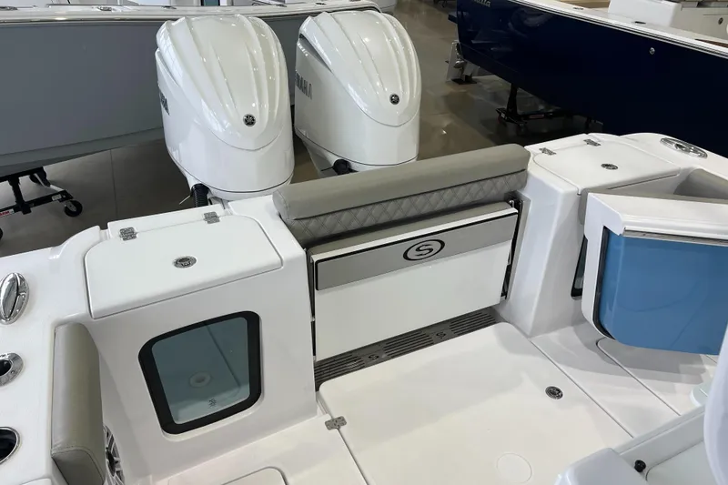 Slide: The Image of 2025 Sportsman Open 282 Center Console boat with dual engines and seating area. - 15