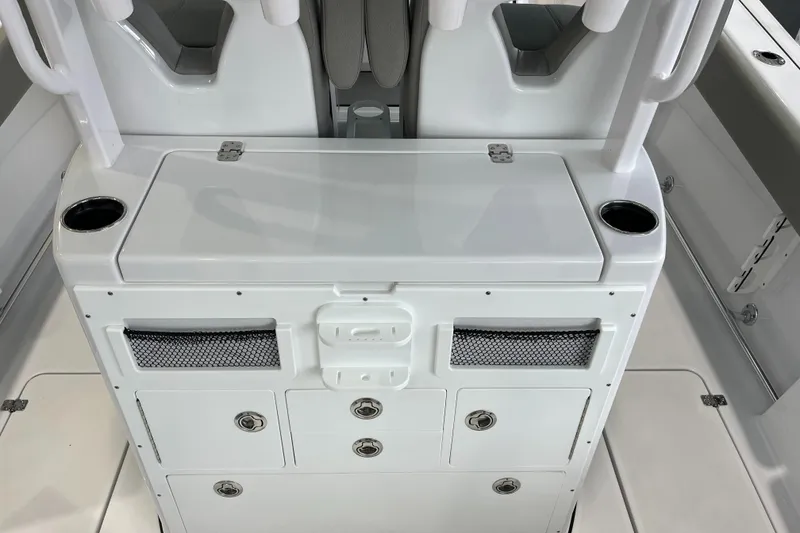 Slide: The Image of 2025 Sportsman Open 282 Center Console boat interior with storage compartments and cup holders. - 16